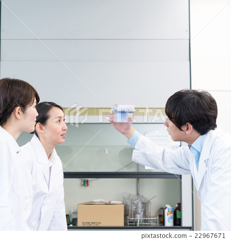 Doctor wearing a white suit to check the results of the examination Doctor wearing a white suit to check the results of the examination 22967671