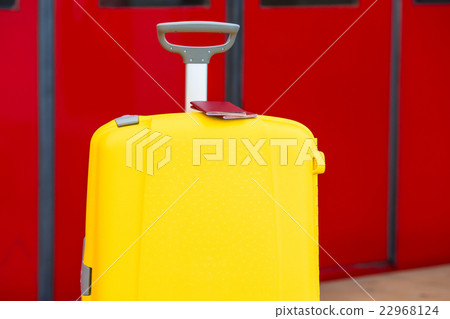 Closeup red passports on yellow luggage at train 22968124