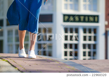 Young beautiful girl walking on bridge in european Young beautiful girl walking on bridge in european 22968320