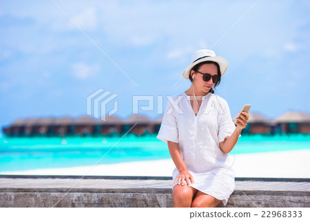 Young beautiful woman on wooden bridge at tropical Young beautiful woman on wooden bridge at tropical 22968333