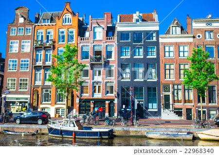 Traditional dutch buildings on canal in Amsterdam Traditional dutch buildings on canal in Amsterdam 22968340