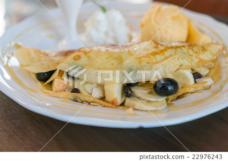 Pancake and fruit with ice cream on table . 22976243