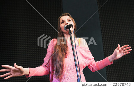 Emotionally singing woman on stage close-up 22978743