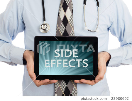 Doctor holding tablet - Side effects 22980692