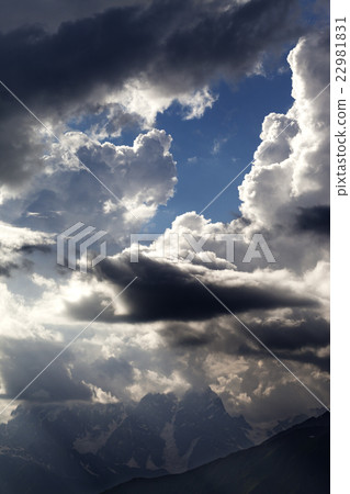 High mountains before rain and sunlight clouds High mountains before rain and sunlight clouds 22981831