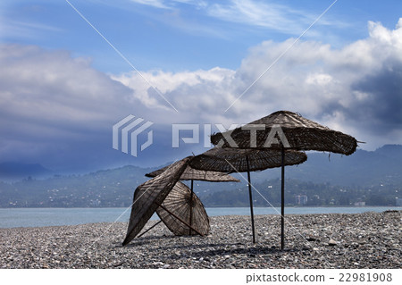 Old sunshade on deserted beach 22981908
