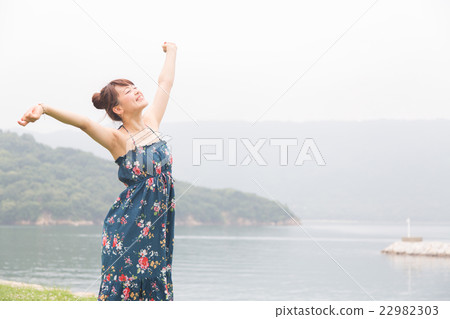 A woman relaxing at the sea 22982303