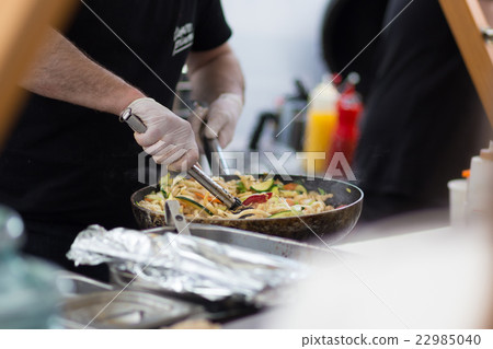 Cheff cooking on outdoor street food festival. Cheff cooking on outdoor street food festival. 22985040