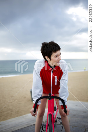 Woman enjoying weekend stroll on rental bike Woman enjoying weekend stroll on rental bike 22985539