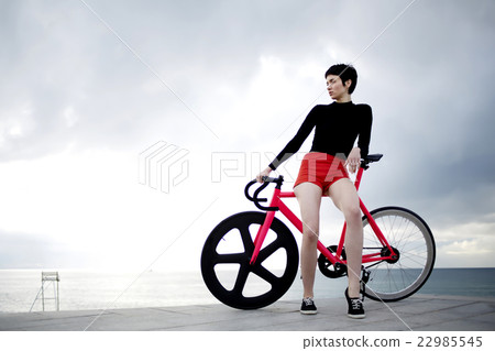 Hipster girl is standing against the sky Hipster girl is standing against the sky 22985545