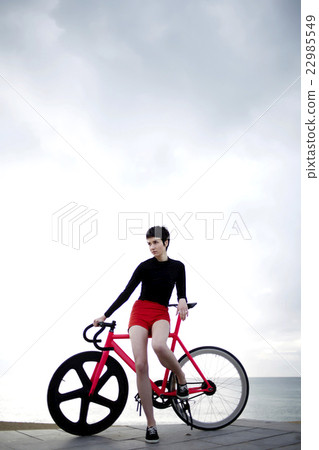 Professional female cyclist enjoying the rest Professional female cyclist enjoying the rest 22985549