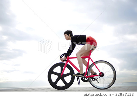 Sporty woman enjoy ride on bicycle in cloudy day Sporty woman enjoy ride on bicycle in cloudy day 22987138