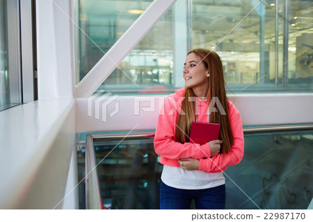 Girl after classes at school resting in hallway Girl after classes at school resting in hallway 22987170