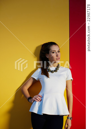 Stylish teenager girl posing on bright background Stylish teenager girl posing on bright background 22987178