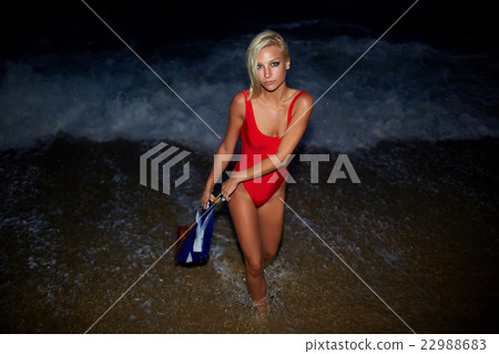 Model posing on the ocean beach at night  22988683