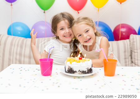 Two little girls at a birthday party Two little girls at a birthday party 22989050