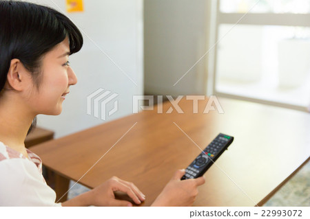 A woman watching TV 22993072