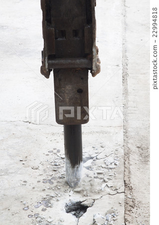 Excavator breaking and drilling the concrete road  22994818