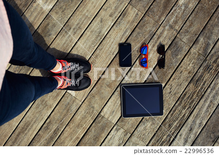 Female legs standing on wooden floor Female legs standing on wooden floor 22996536