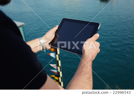 Male holding touch screen tablet Male holding touch screen tablet 22996543