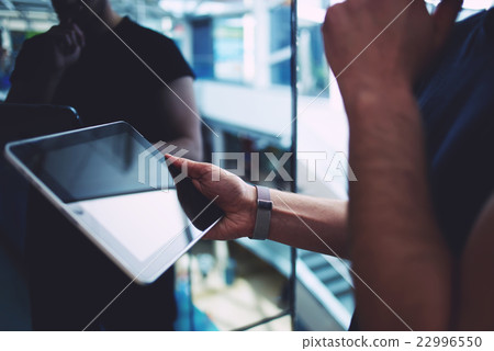 Young successful browsing on pad Young successful browsing on pad 22996550