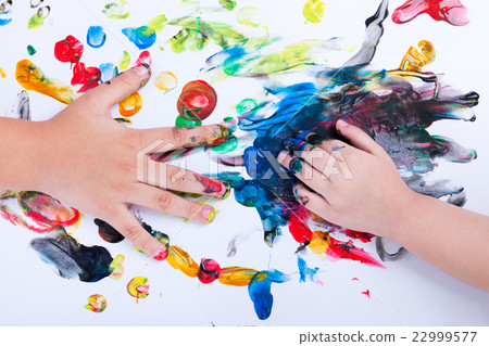 Closeup of children hands doing finger painting  22999577