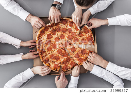 Business team eating pizza Business team eating pizza 22999857