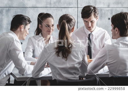 Business team eating pizza Business team eating pizza 22999858