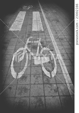 Bicycle lane signage on street, black and white 23002166
