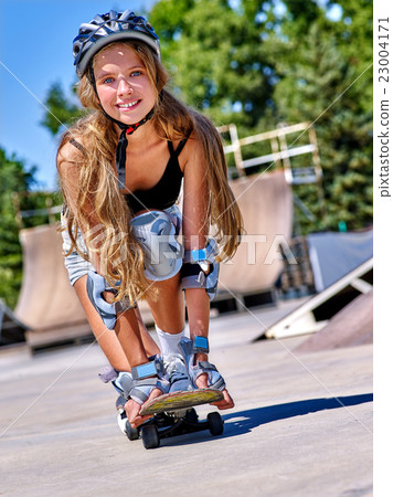 Teen girl rides his skateboard 23004171