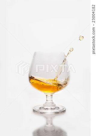 Whiskey splashing into the glass Whiskey splashing into the glass 23004182
