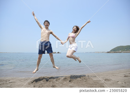 Young couple jumping at the sea Young couple jumping at the sea 23005820