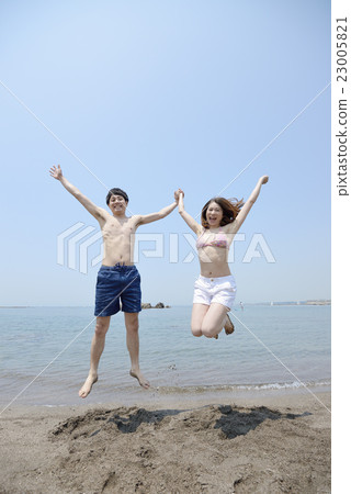 Young couple jumping at the sea Young couple jumping at the sea 23005821