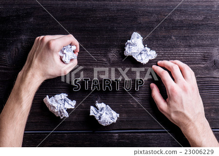 Desk with start up sign, hands of unrecognizable 23006229