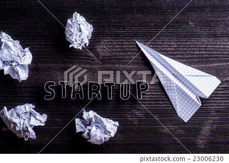 Desk, start up sign, airplane and crumpled paper Desk, start up sign, airplane and crumpled paper 23006230