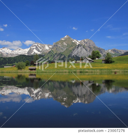 Alpstein range mirroring in lake Schwendisee 23007276