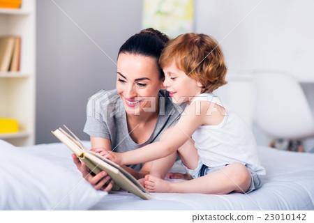 Mother and child reading a book 23010142