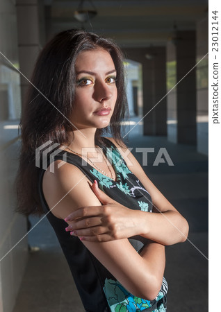Beautiful young girl in dress in town Beautiful young girl in dress in town 23012144