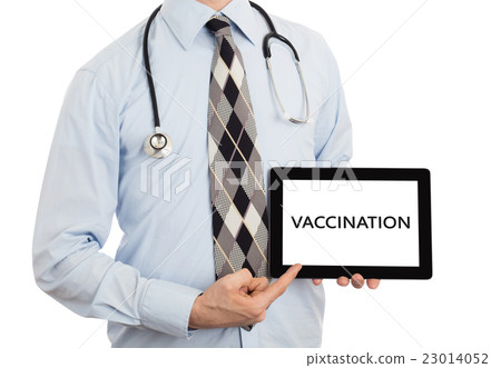 Doctor holding tablet - Vaccination Doctor holding tablet - Vaccination 23014052