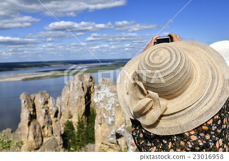 Woman taking picture at viewpoint of Lena Pillars 23016958
