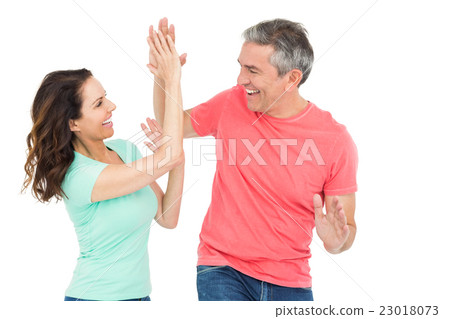 Excited couple giving a high-five Excited couple giving a high-five 23018073