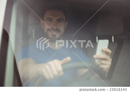 Delivery man driving his van 23018143