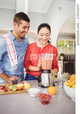 Laughing couple with fruit juice 23018207