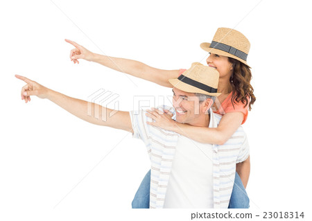 Handsome man piggy backing his wife Handsome man piggy backing his wife 23018314