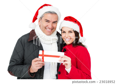 Festive couple holding christmas gift Festive couple holding christmas gift 23018952