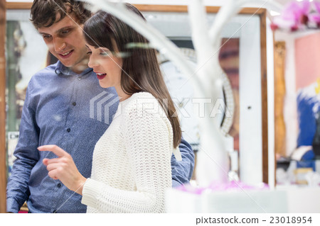 Happy couple shopping in mall 23018954