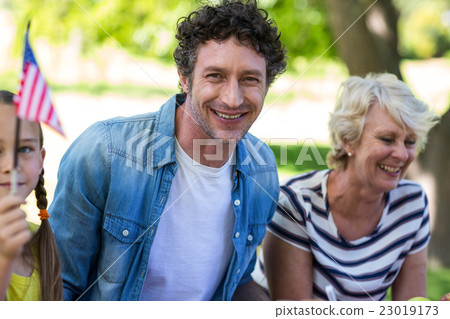 Family with an American flag sitting 23019173
