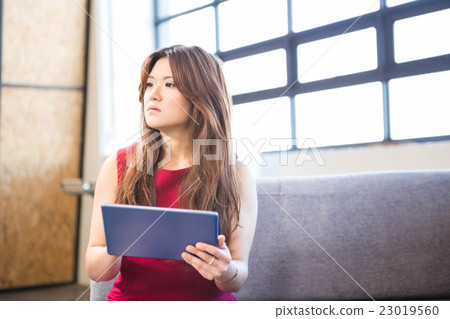 Businesswoman using digital tablet Businesswoman using digital tablet 23019560