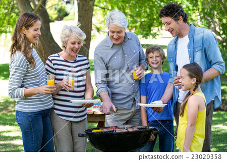 Family having a barbecue Family having a barbecue 23020358