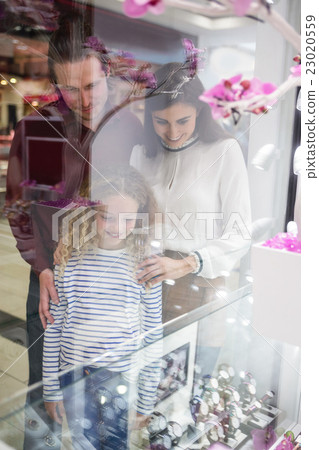 Happy family window shopping in mall 23020559